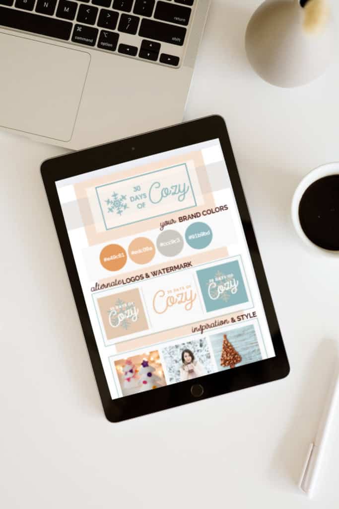 flat lay of a desk with laptop and a tablet showing a crochet business rebrand color palette and brand board