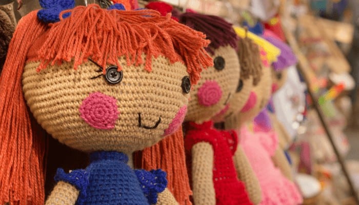 Photo of various hanging crocheted amigurumi dolls