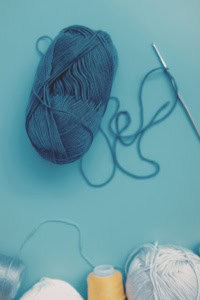 Handmade with Love Super Bundle - image of skeins of yarn, some unwound, and a crochet hook
