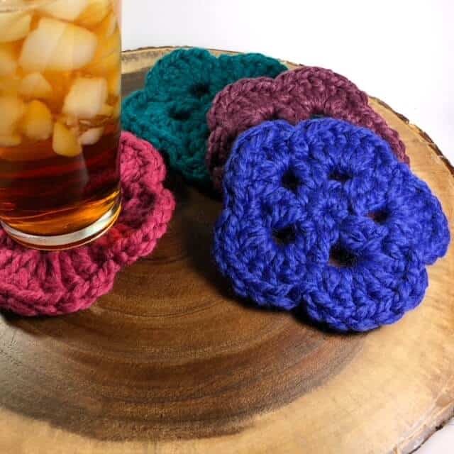 Photo of 4 crocheted Coasters with a glass of iced sweet tea