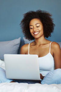 Link Parties - image of a woman smiling, using a laptop