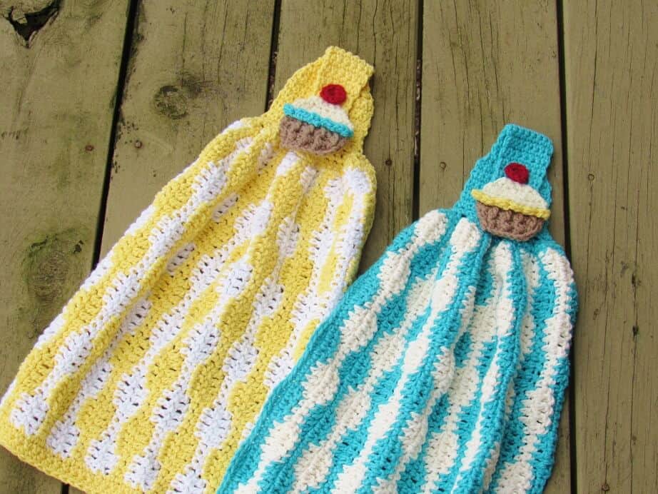 Photo of 2 Crochet Pot Holders and Towels Pattern laid down on a wooden table