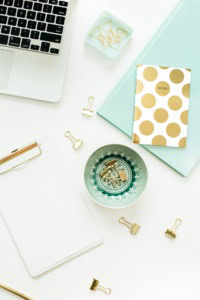 best link parties for crochet - image of an office workspace with laptop, notebooks, a clip board, and binder clips