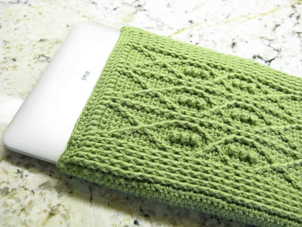 Photo of an iPad with a crocheted cover with fish details