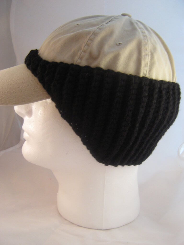 Photo of a cap on a mannequin head with a crocheted baseball cap ear warmer