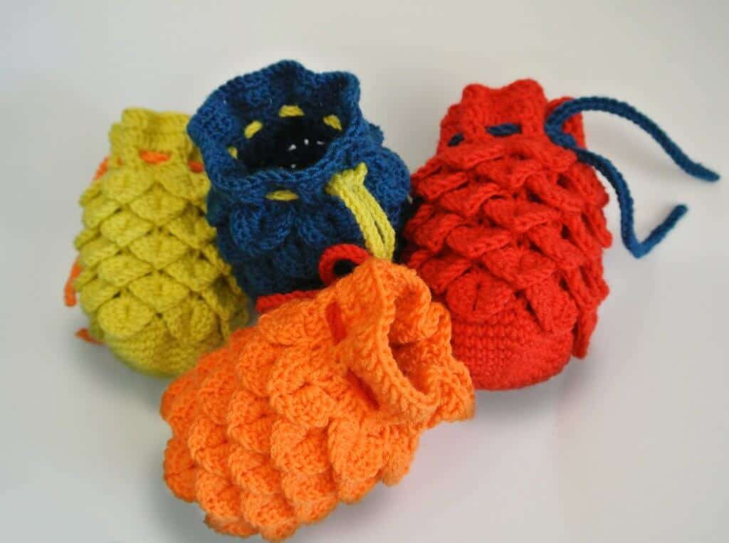 Image of four crocheted dragon egg dice bag