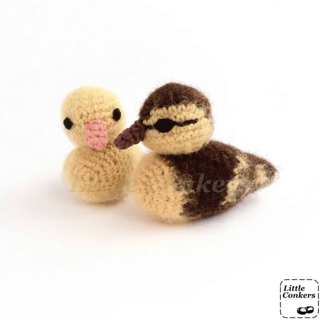 Photo of two realistic crocheted duckling