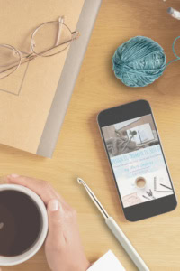 how to sell patterns - image of a crochet workspace with a mobile phone, showing a preview of the Design it, Make it, Sell it resource