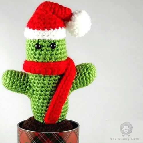 Image of the crocheted St. Prickolaus Cactus wearing a Santa hat and red scarf
