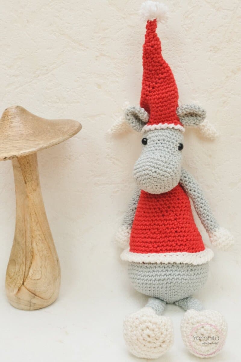Pinterest photo of the crocheted Christmas elk wearing a red Santa hat