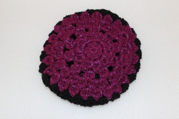 Photo of the crown of the colorful crochet beanie with while background