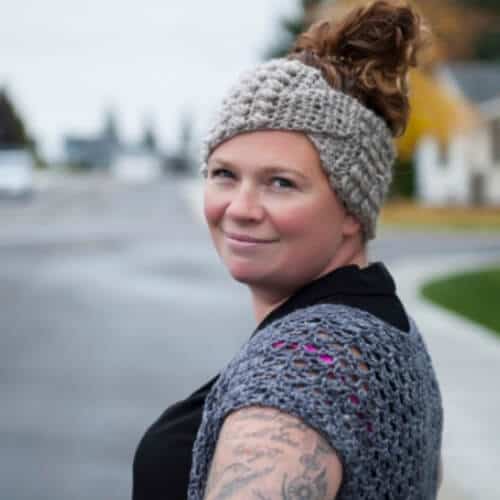Photo of a woman wearing the crocheted twisted headband ear warmer
