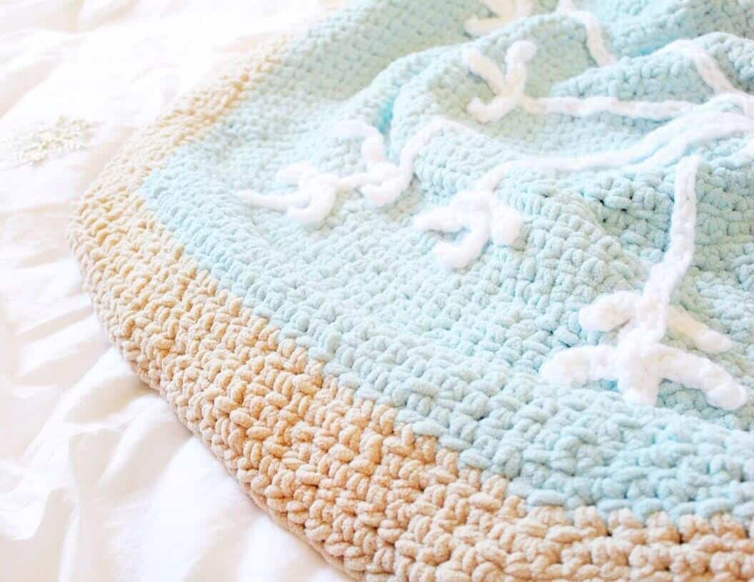 Close up photo of the Snowflake Sugar Cookie Blanket on a white sheet