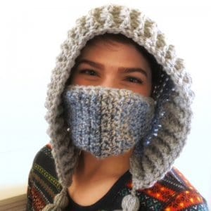 A woman wearing the crocheted Snow Day Hood with mask