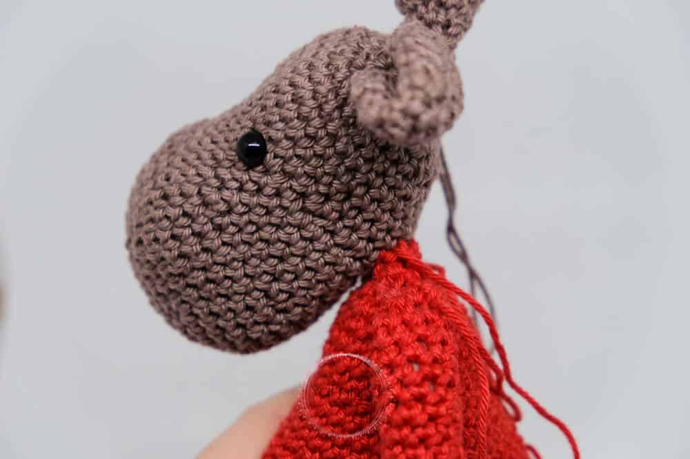 Instructional image while assembling the Einar Christmas Elk FREE Amigurumi Crochet Pattern
