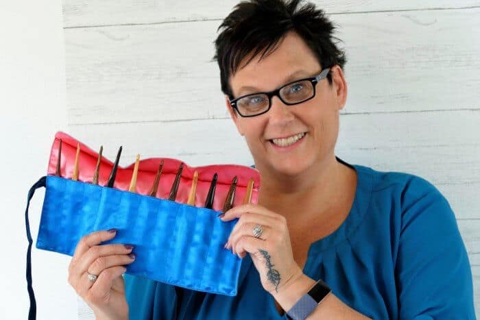 Photo of Pam Grice Holding a Variety Set of Laurel Hill Wooden Crochet Hooks with Holder