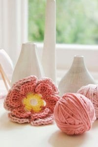 may income report featured image, some white vases and a pink crocheted flower