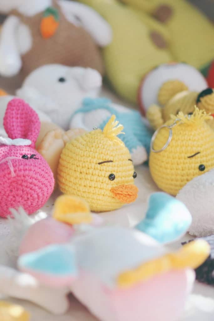 An assortment of small crochet stuffies including chicks and a bunny.