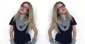 A mirror image of a young blonde woman wearing a scarf