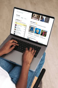 marketing-patterns-on-ravelry - image of hands on a laptop keyboard. on screen is a sample Ravelry crochet patterns page