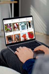 marketing-patterns-on-etsy - image of hands on a laptop keyboard. on the screen is a the Made with a Twist Etsy shop.