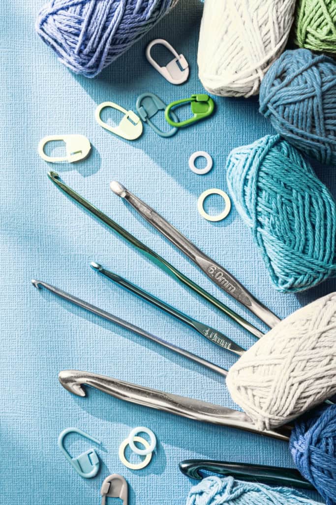 introducing the Crochet Business Chat podcast - image of an array of yarn, crochet hooks, and notions