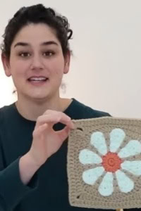 Elyse Myers showing a crochet flower square that was the center of an intellectual property controversy