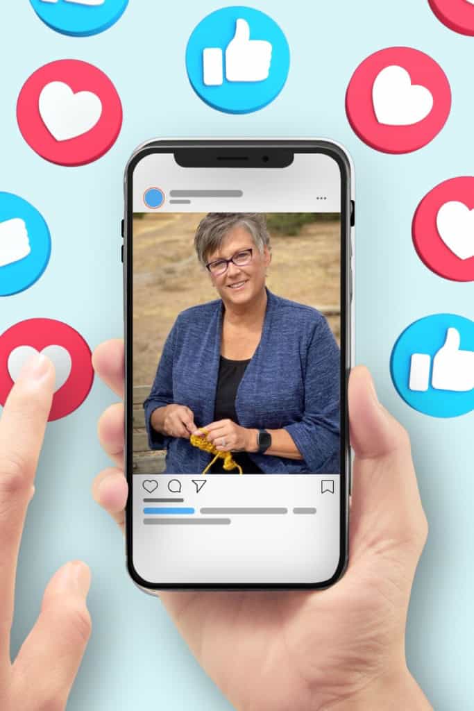 image of a hand holding a cell phone, with a social media image of Pam Grice. It's surrounded by "like" and "heart" reactions