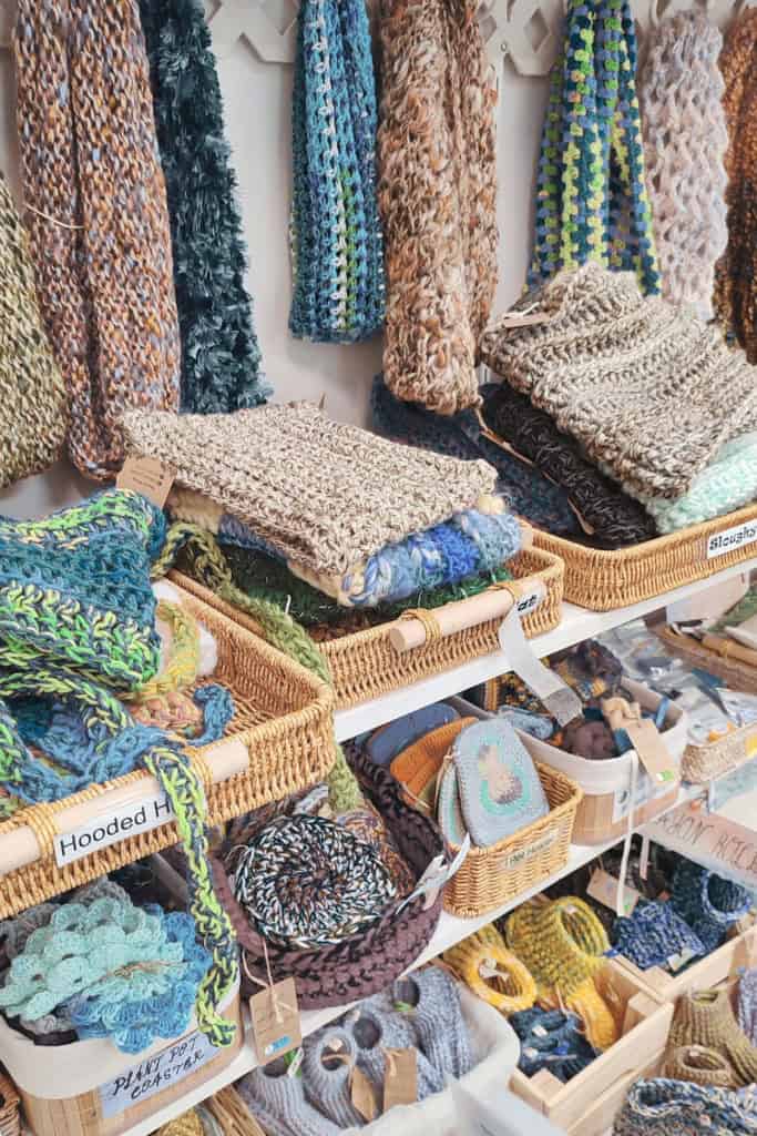 crocheted items displayed in baskets at a craft fair