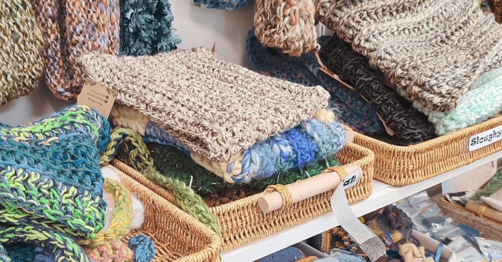 crocheted items displayed for sale in baskets