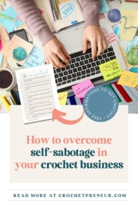 How to Stop Self-Sabotaging Your Crochet Business - Pin image featuring a cluttered desk with a laptop, sticky notes, balls of yarn and crochet hooks