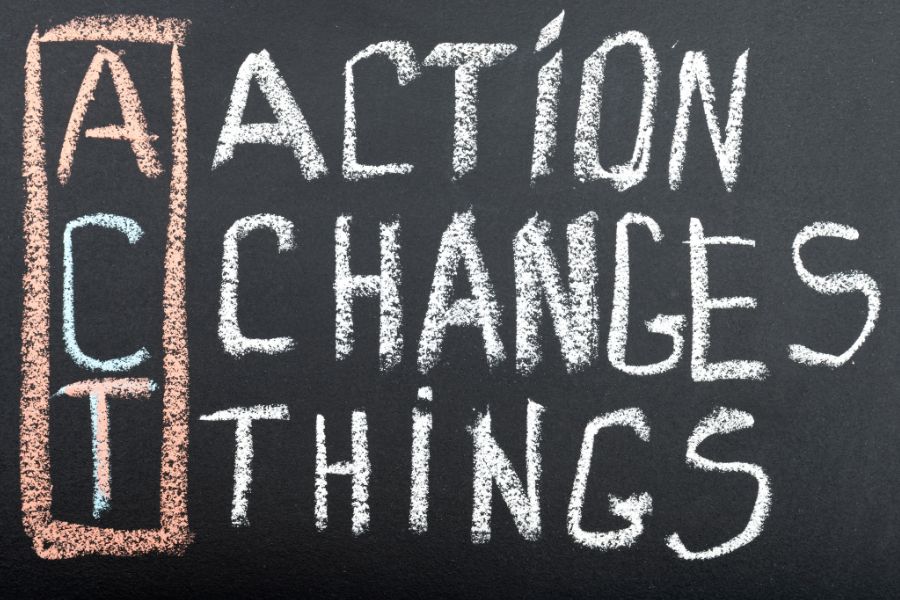 Image of a chalkboard. Written on it is the acronym ACT - Action Changes Things