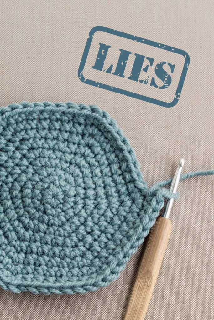 Crochet Business Lies - a crochet project in progress, with a graphic stamped over top that reads "lies"