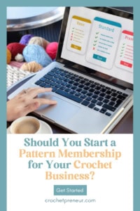 How To Start a Crochet Pattern Membership Business - shows a hand operating a laptop, which shows a subscription site on the screen. The laptop is surrounded by a cup of coffee, a crochet hook, and a basket of yarn.
