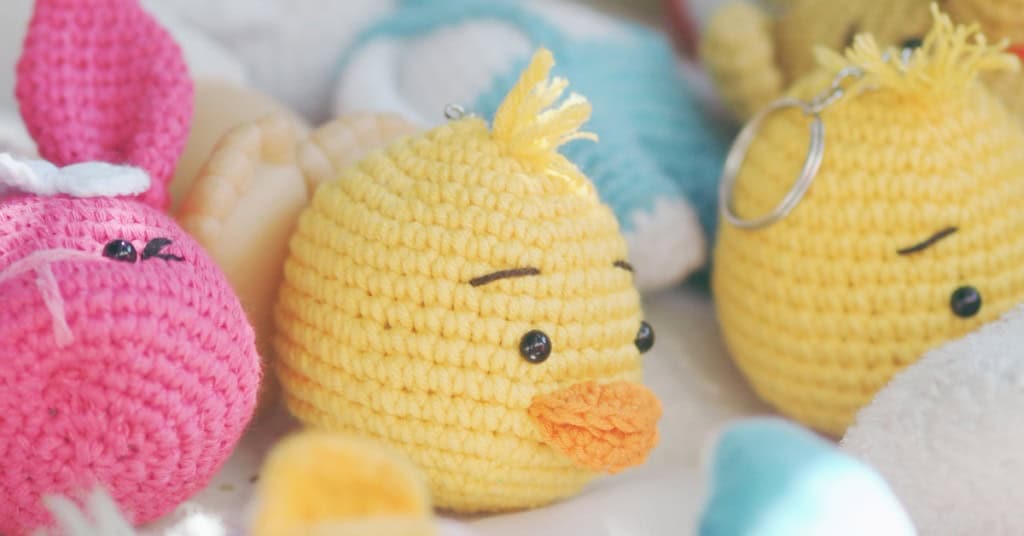An assortment of small crochet stuffies including chicks and a bunny.